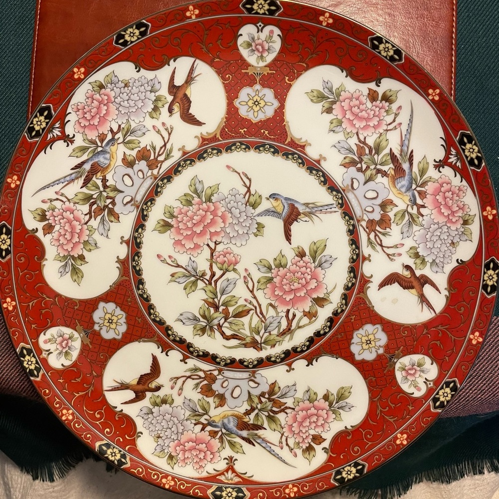 Oriental decorative plate featuring floral design with birds.